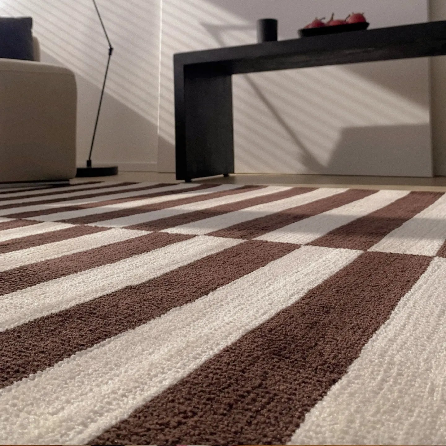 Close-up of Clara White and Chocolate Brown Modern Offset Stripe Rug by Housenfriends in the living room