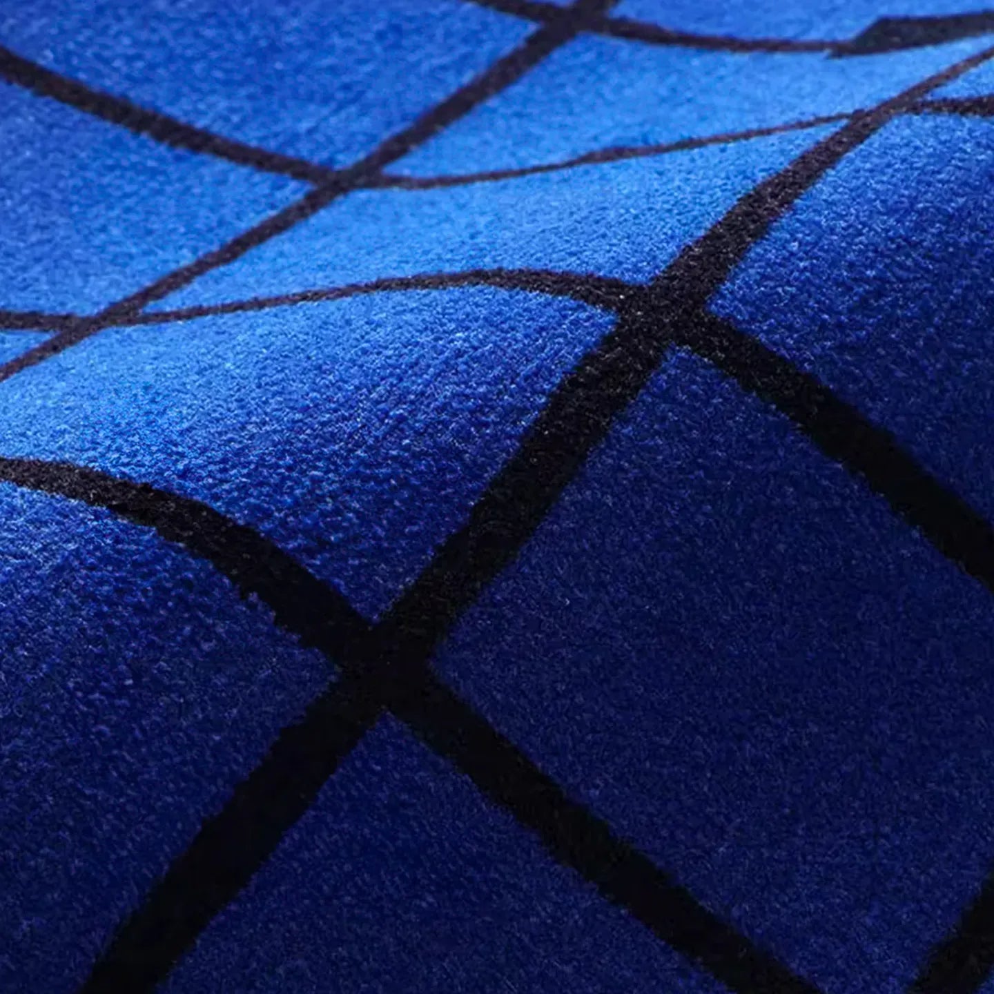 Close-up of the blue section of the Poolside blue and white grid modern graphic rug by Housenfriends