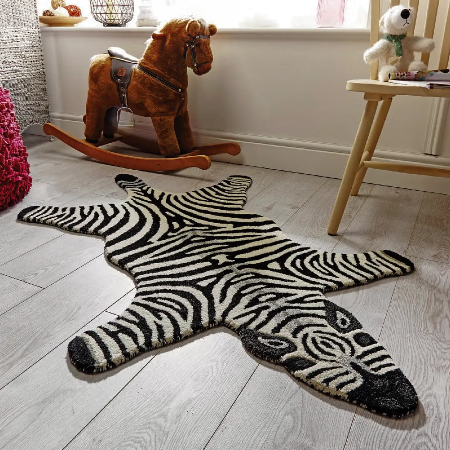 Zibi small zebra animal shaped rug in black and white by Housenfriends on a wooden floor with toys