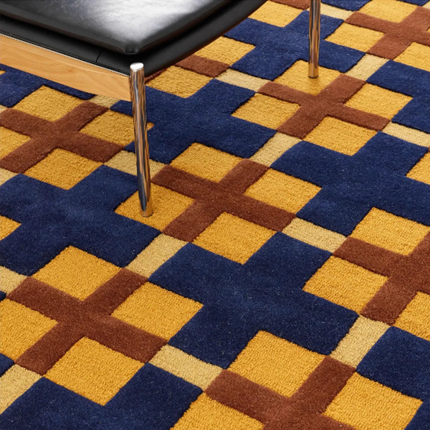Close-up of the Juno mustard, gold, and navy checkered tufted rug by Housenfriends in a living room