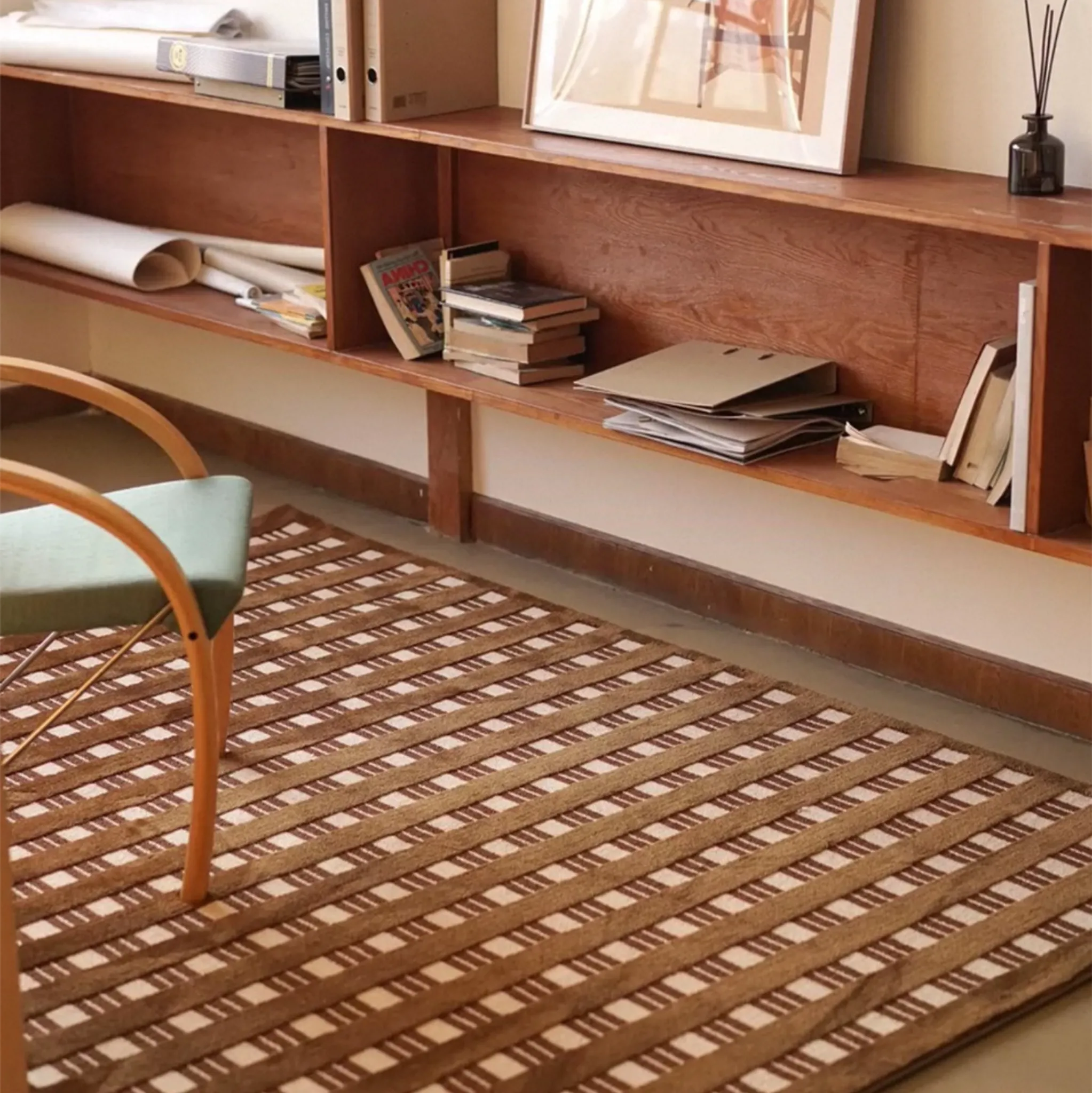 Wooden shelf with books and a chair on Amber Brown and Cream Checkered Textured Modern Rug by Housenfriends