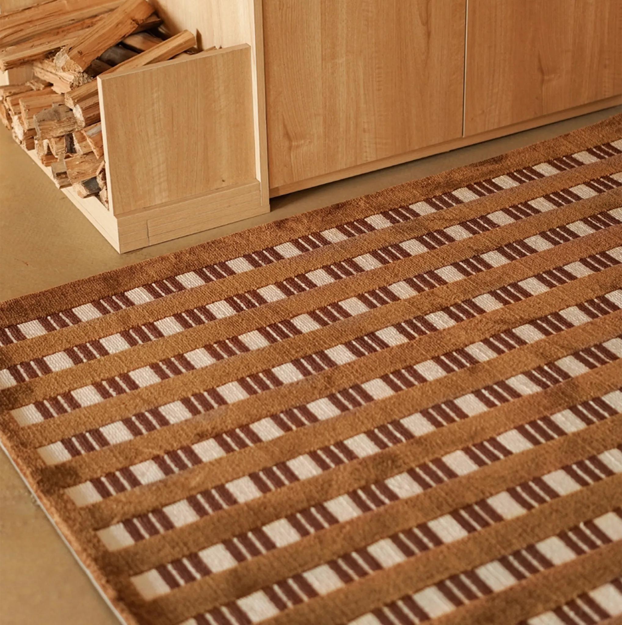 Amber Brown and Cream Checkered Textured Rug with wooden cabinet and firewood in the background