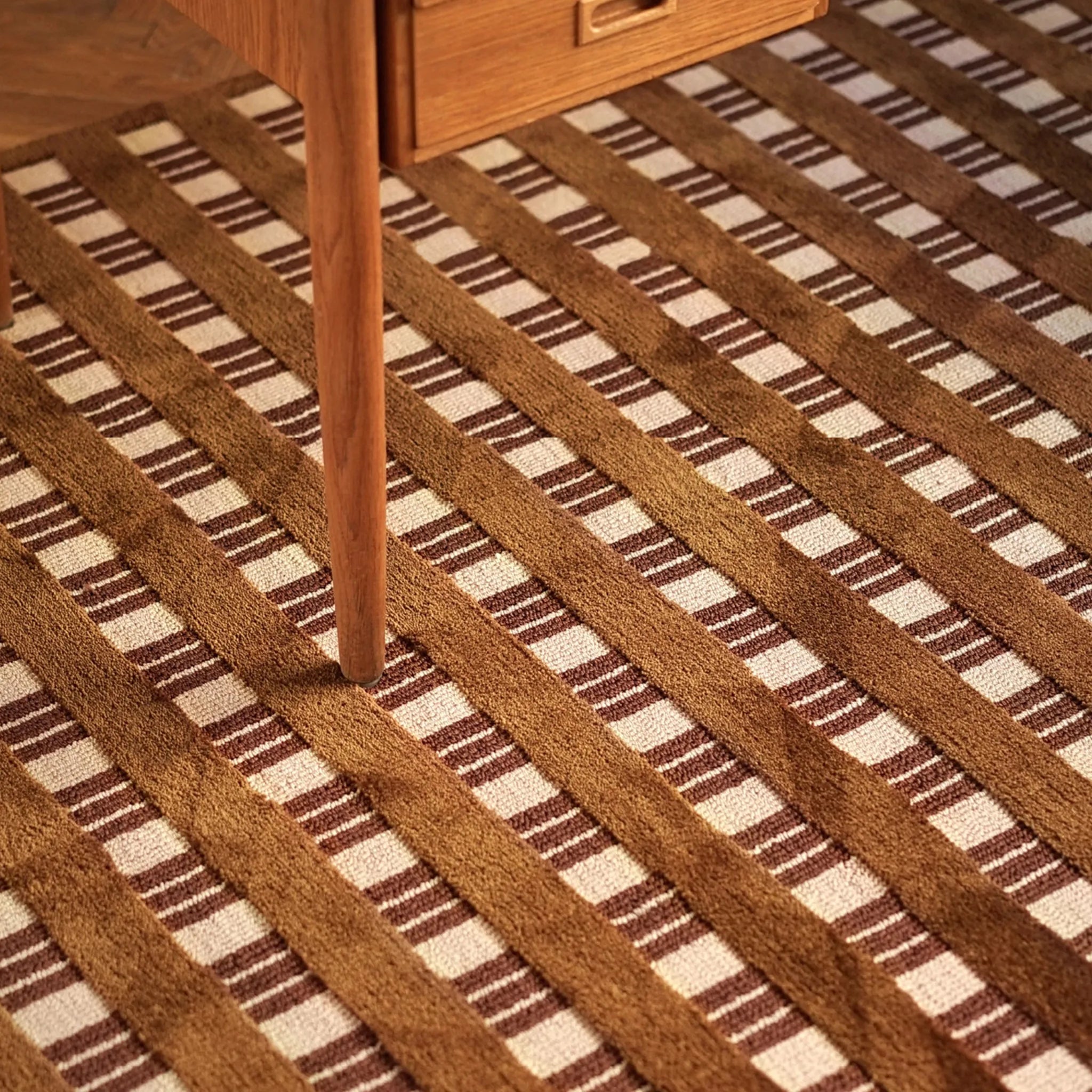 Amber Brown and Cream Checkered Textured Modern Rug with a wooden leg partially visible