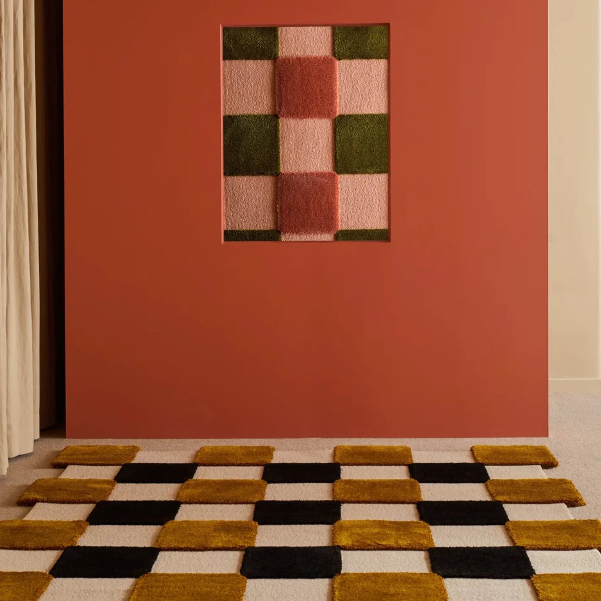 Wall with pink and green checkered design and Brown Black Ivory Checkered Irregular High Low Rug on floor.