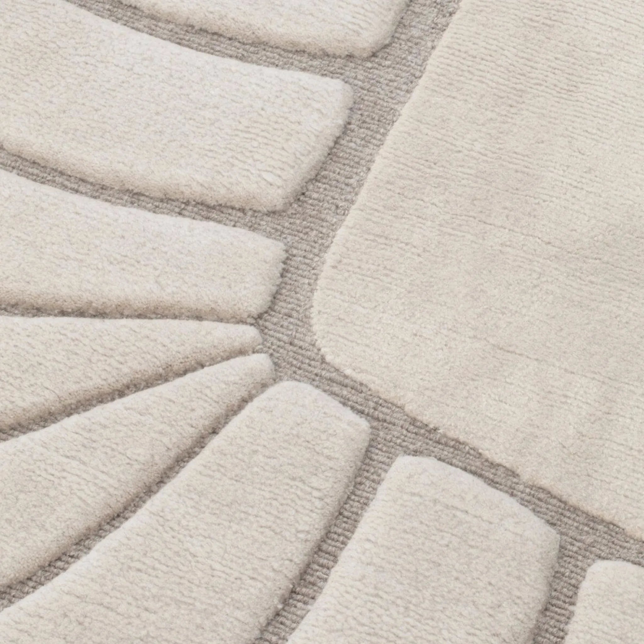 Close-up of a texture of Coquille Cream Seashell Shaped Sculpted Rug by Housenfriends