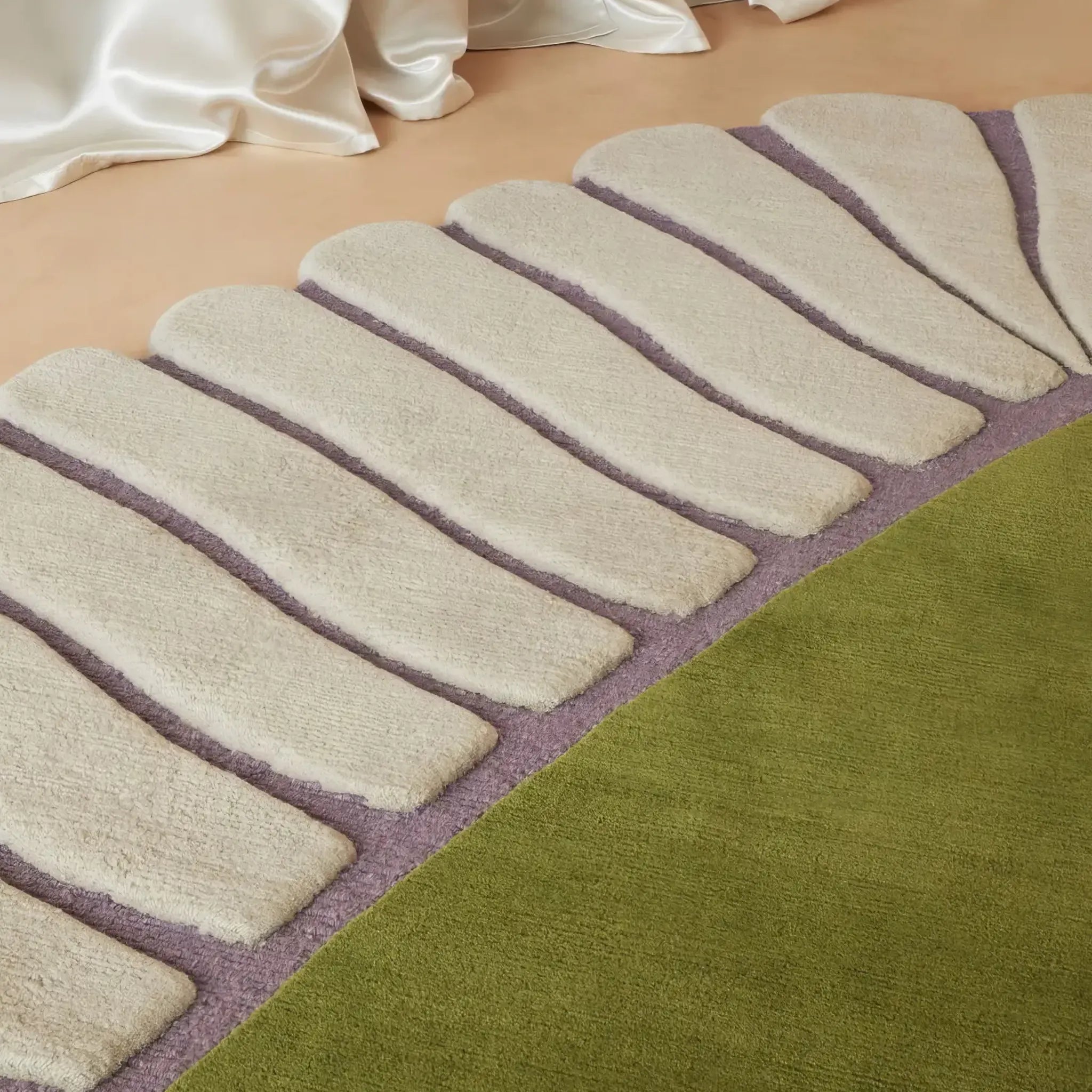 Close-up of a texture of Green Seashell Shaped Sculpted Rug with cream boarder by Housenfriends on a beige floor