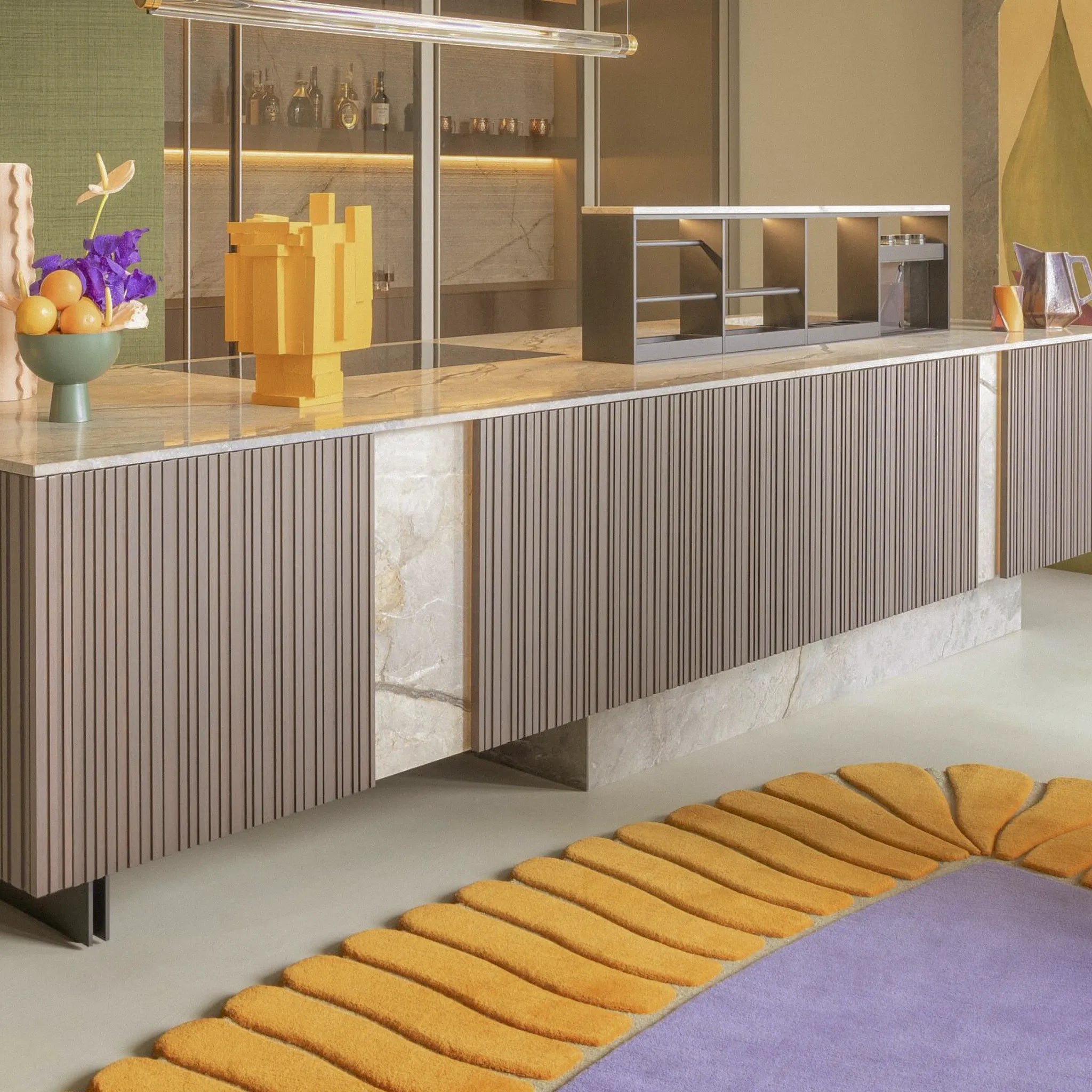 Modern interior with a long sideboard, decorative items, and Coquille Purple Orange Seashell Shaped Sculpted Rug by Housenfriends