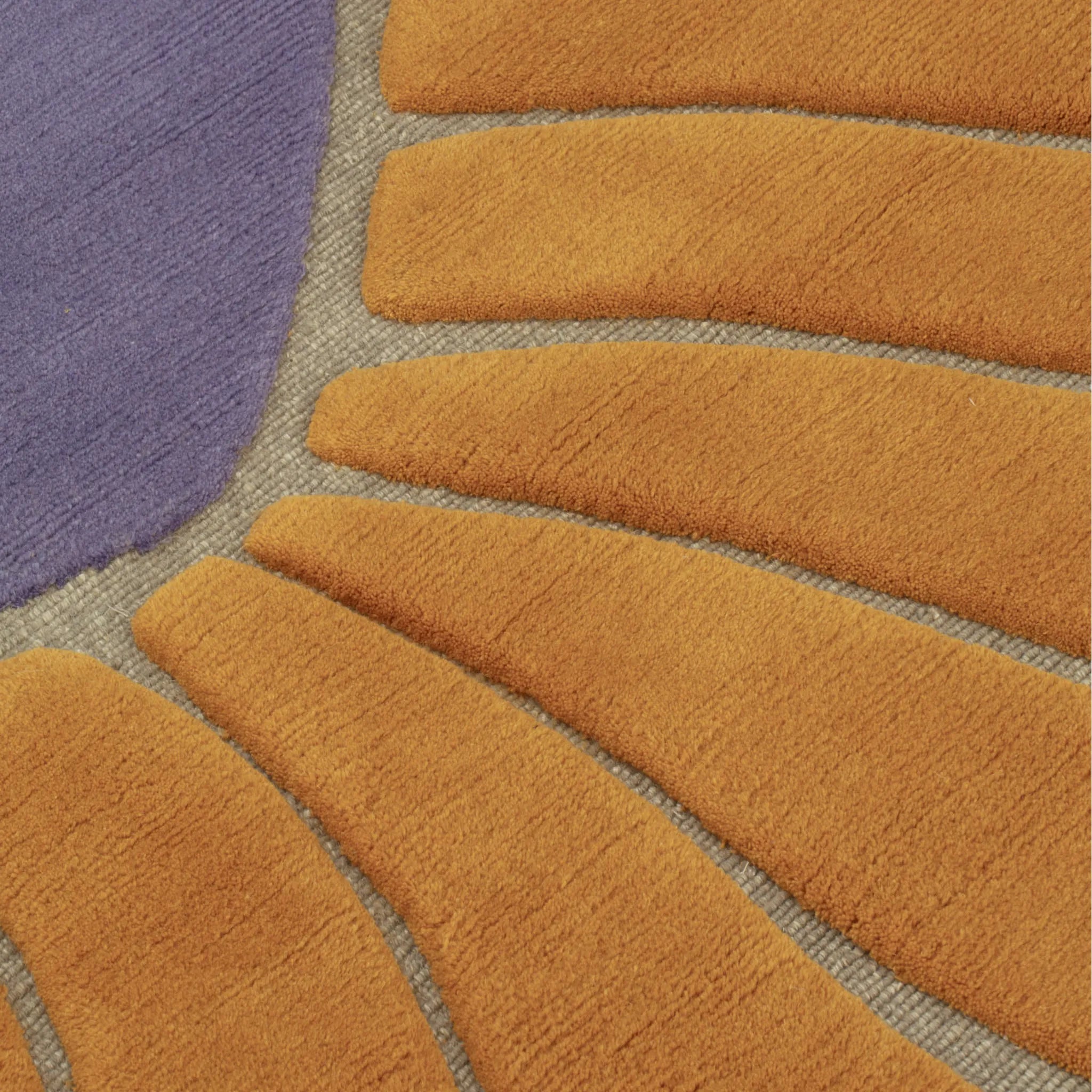 Close-up of the texture of Coquille Purple Orange Seashell Shaped Sculpted Rug by Housenfriends