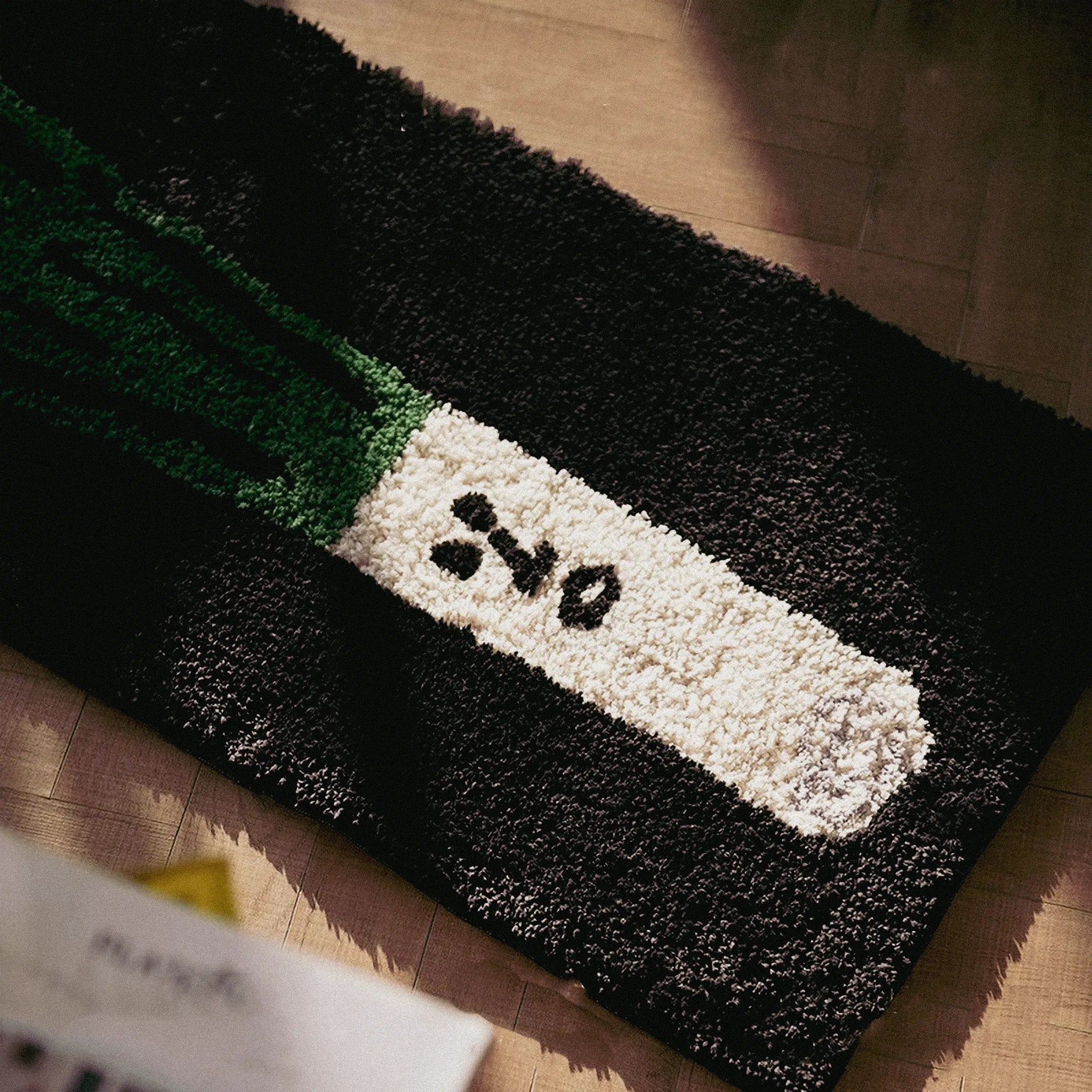 Close-up of Green Onion Playful Black Runner Rug by Housenfriends on floor with sunlight streaming across it