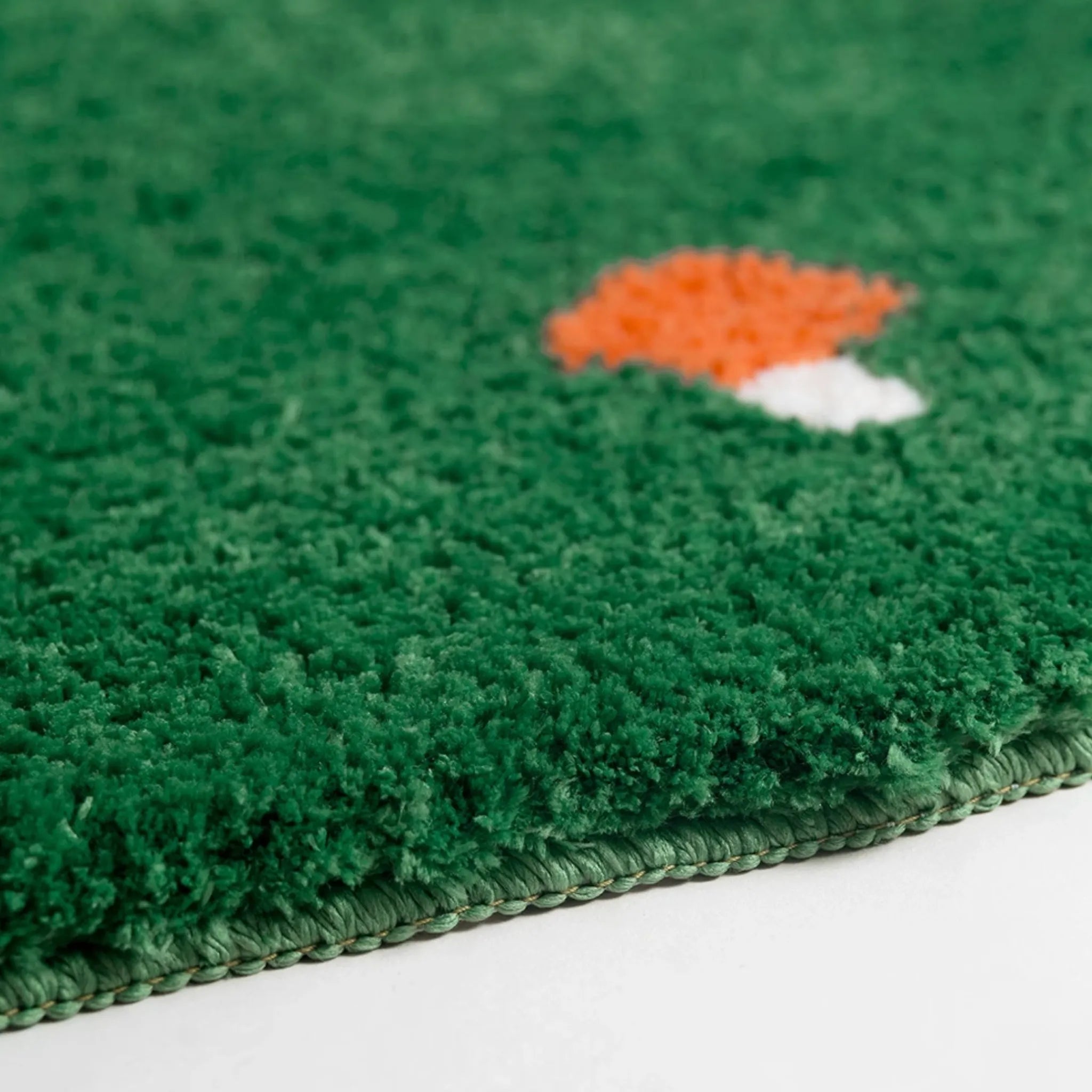 Close-up of a green textured surface of Elora Moss Green Round Mushroom Tufted Rug by Housenfriends.