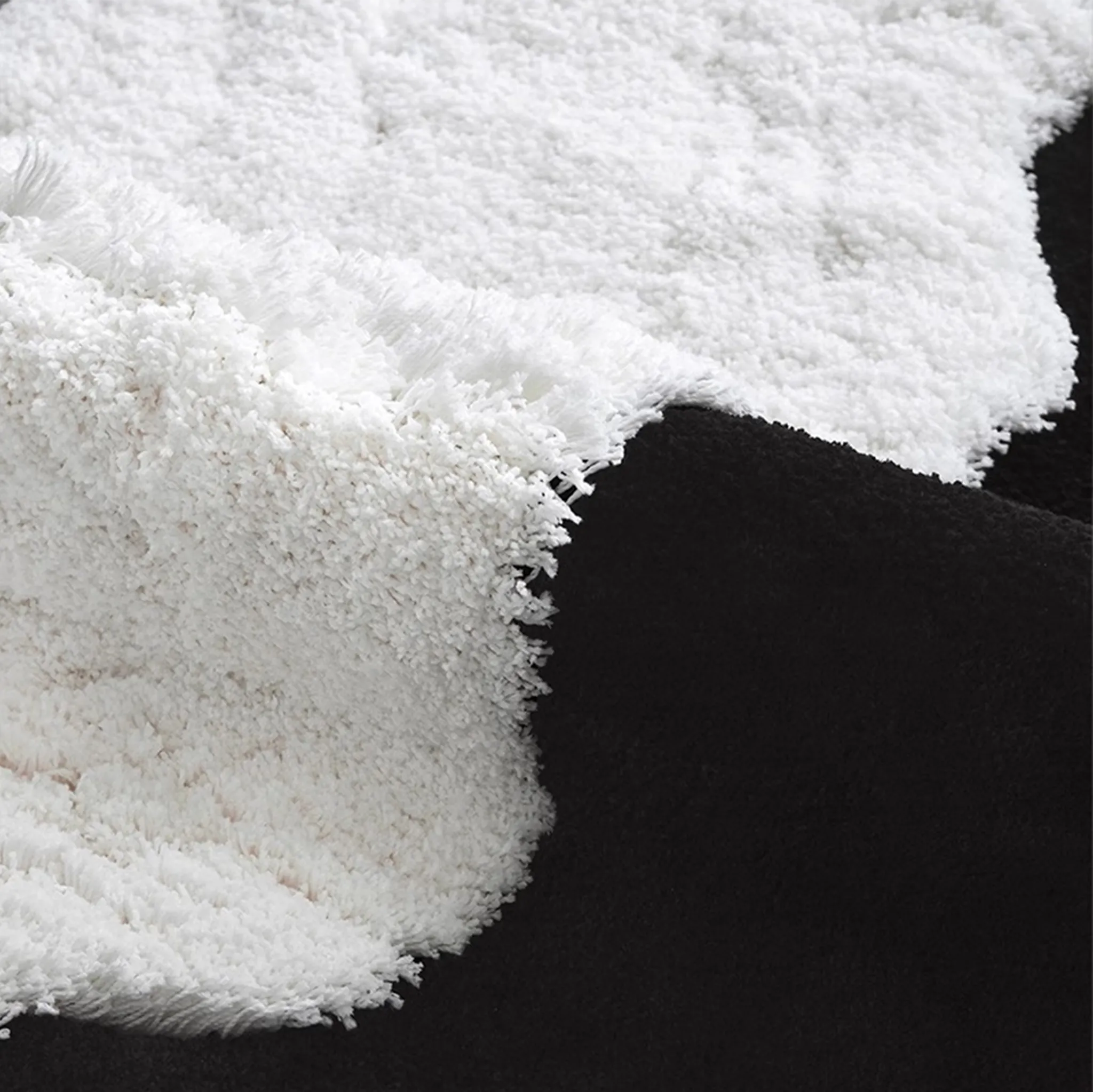 Close-up of the white fluffy material of the Black Shore White Waves high-low rug.