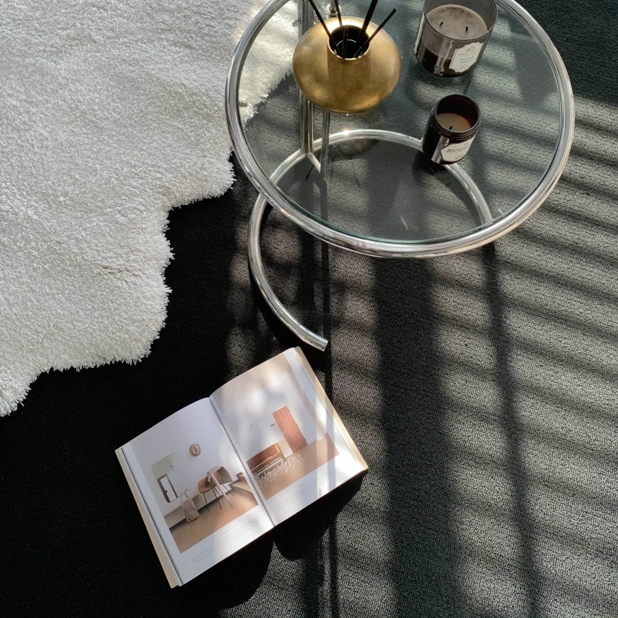 Glass side table with candles on Reynisfjara Black Shore White Waves Abstract High Low Rug by Housenfriends