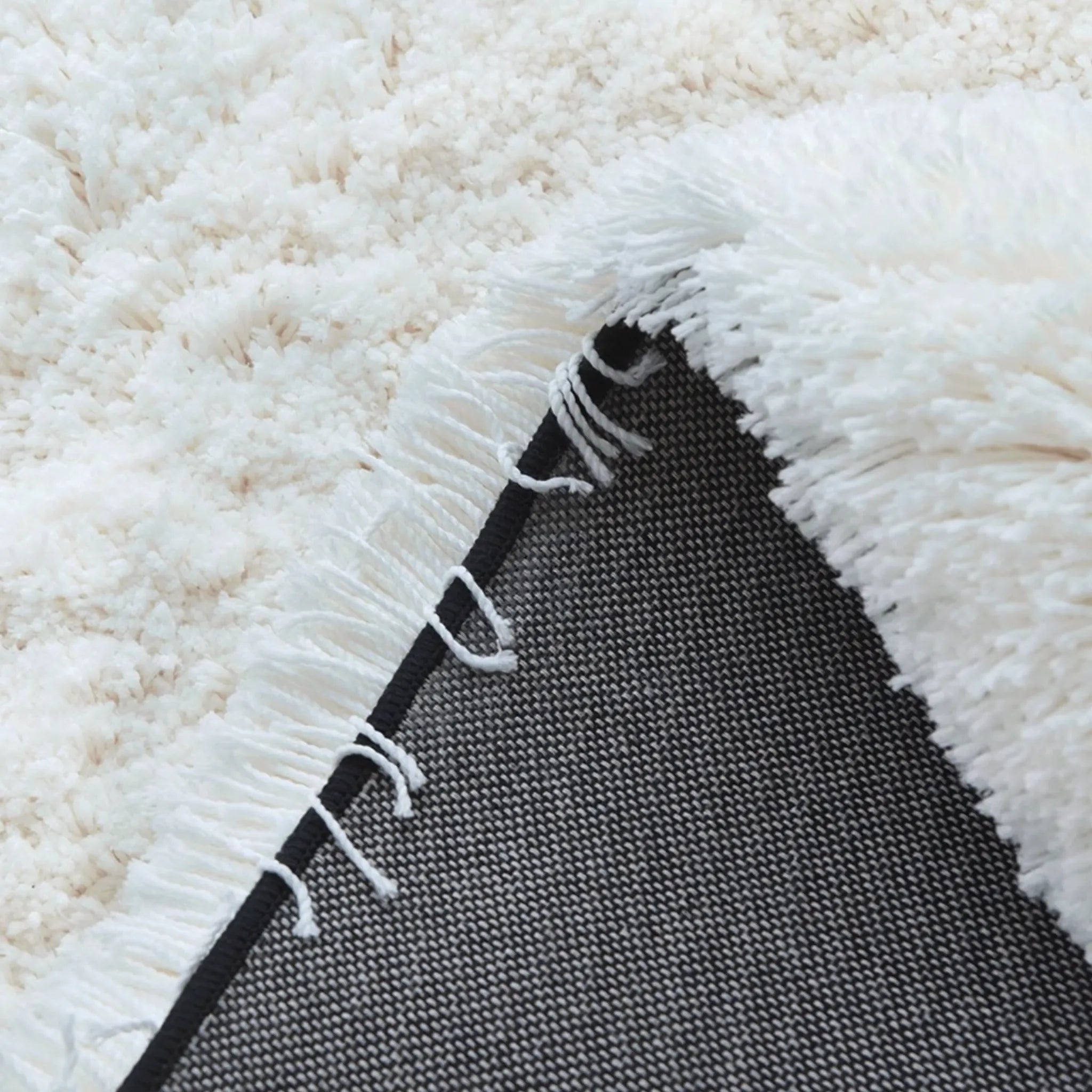 Close-up of a white texture of the Black Shore White Waves high-low rug.