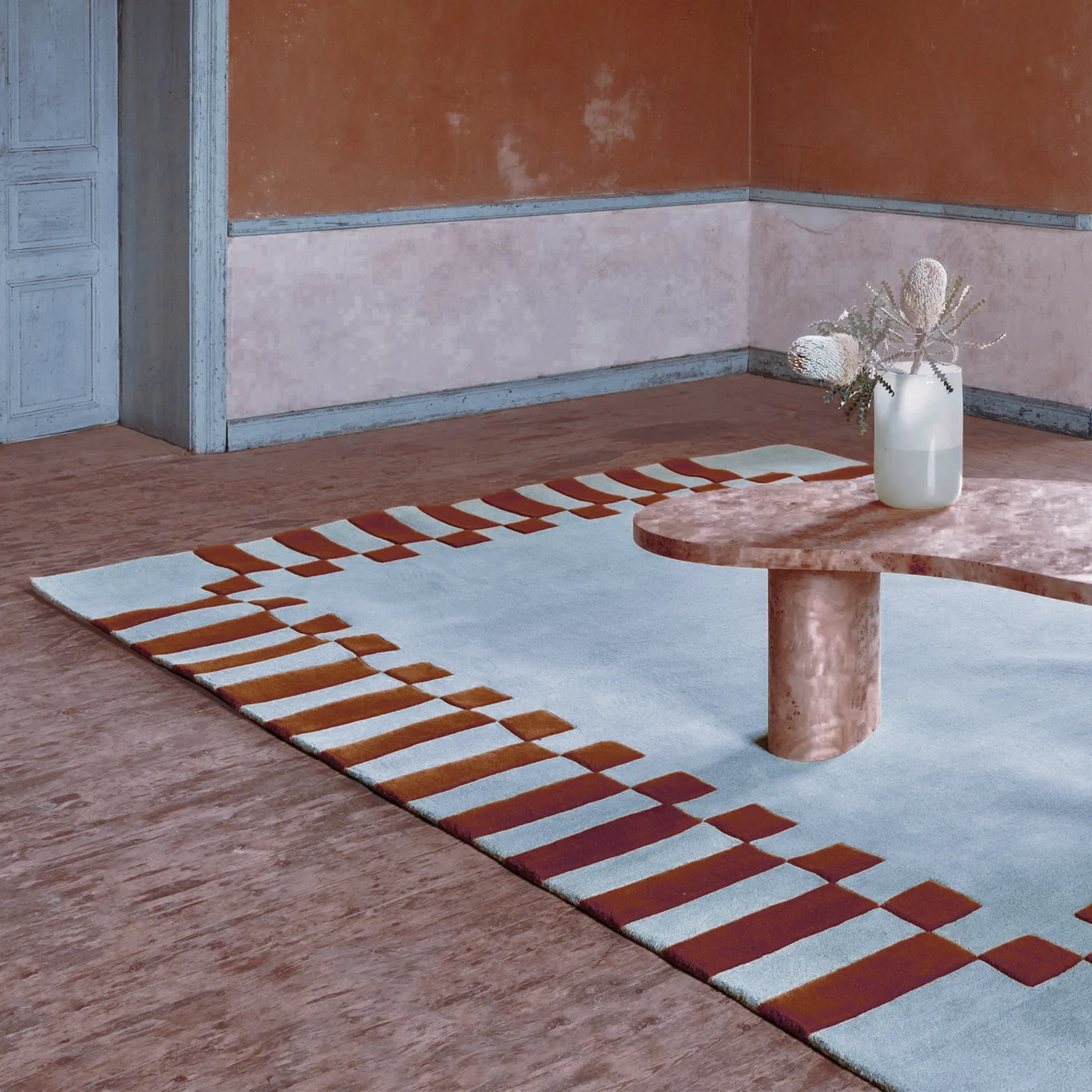 Acropolis Slate Blue and Red High Low Wool Rug by Housenfriends on floor with a minimalistic interior design.