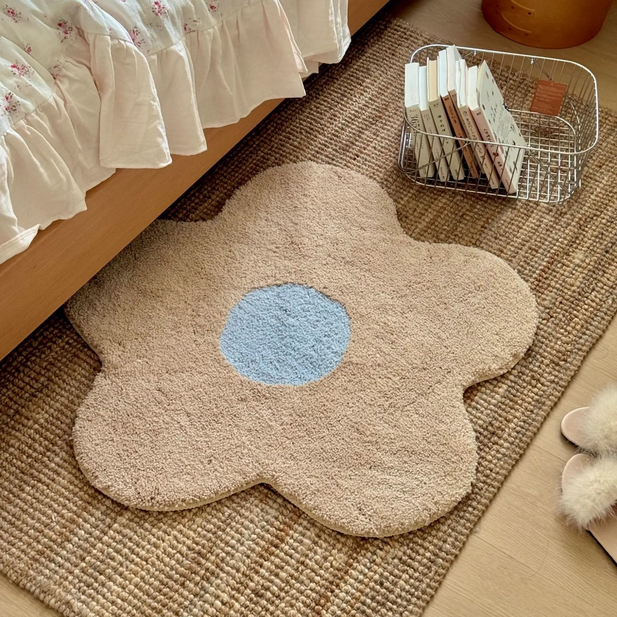 Maisie Cream & Pale Blue Daisy Flower Shaped Tufted Rug by Housenfriends layered over a woven rug beside a bed, a soft cottagecore flower rug.