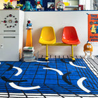 Colourful chairs on the Poolside blue and white abstract checkered rug by Housenfriends, with toys and furniture
