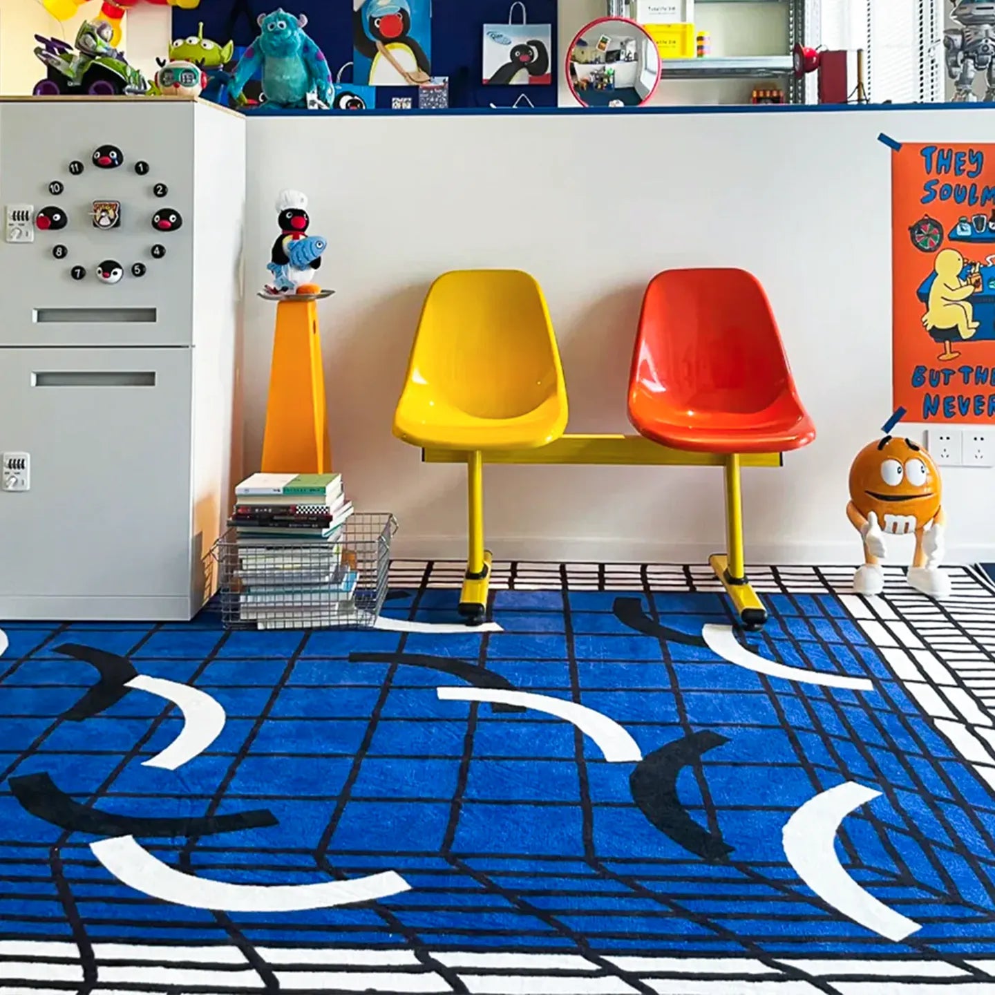 Colourful chairs on the Poolside blue and white abstract checkered rug by Housenfriends, with toys and furniture