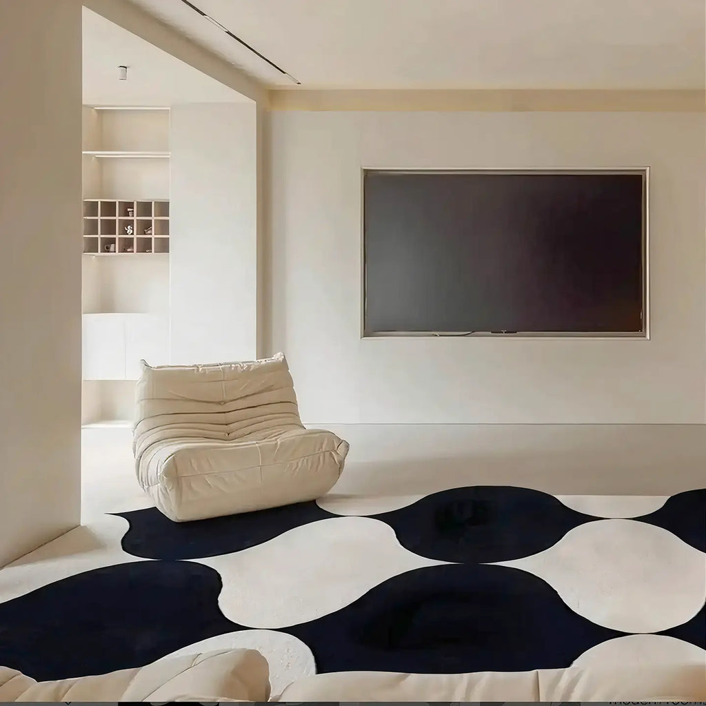 Modern living room with Nova black and white irregular wavy rug by Housenfriends with a white armchair and a flat-screen TV
