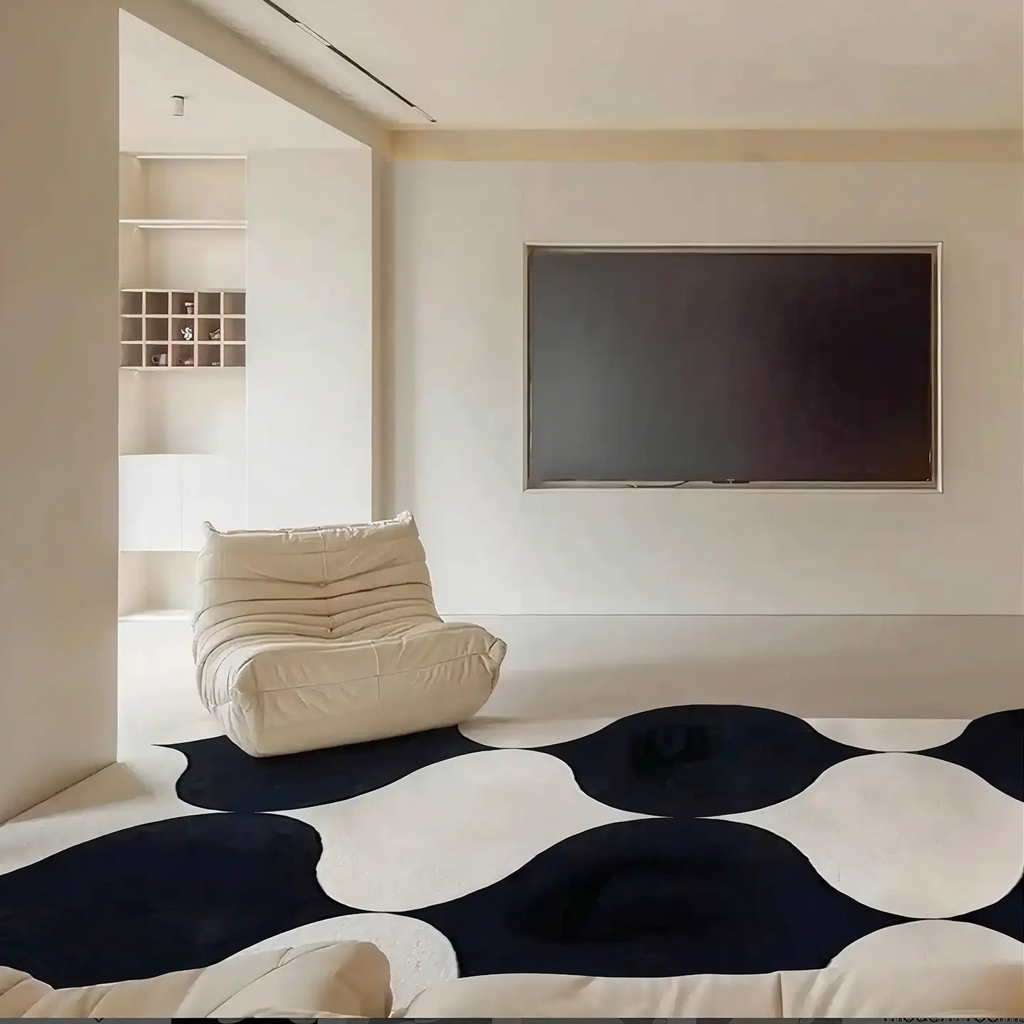 Modern living room with Nova black and white irregular wavy rug by Housenfriends with a white armchair and a flat-screen TV