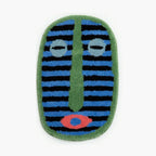 Milo green small oval shaggy modern African mask rug by Housenfriends on white background