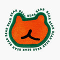 Doki orange small shaggy bear-shaped rug with green outline by Housenfriends on white background