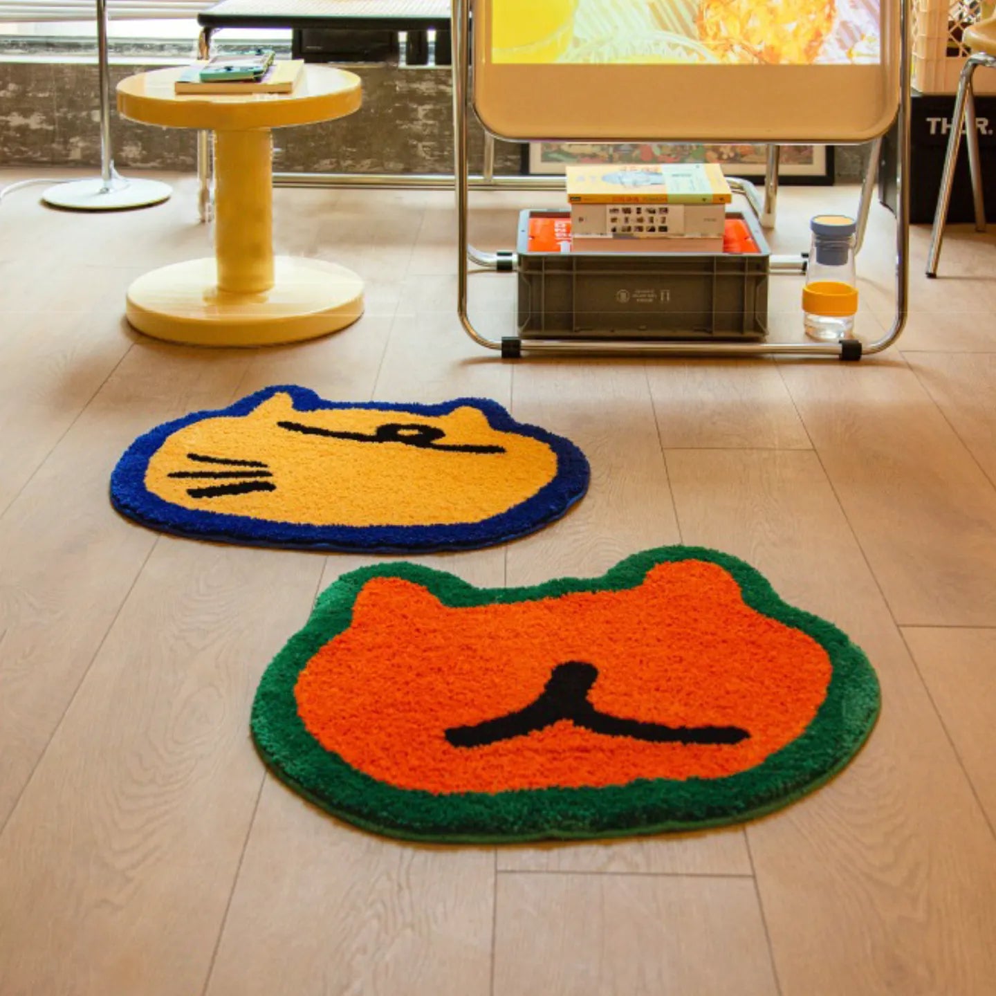 Doki orange bear-shaped rug and Poki yellow cat-shaped rug, hand-tufted by Housenfriends on wooden floor with modern room