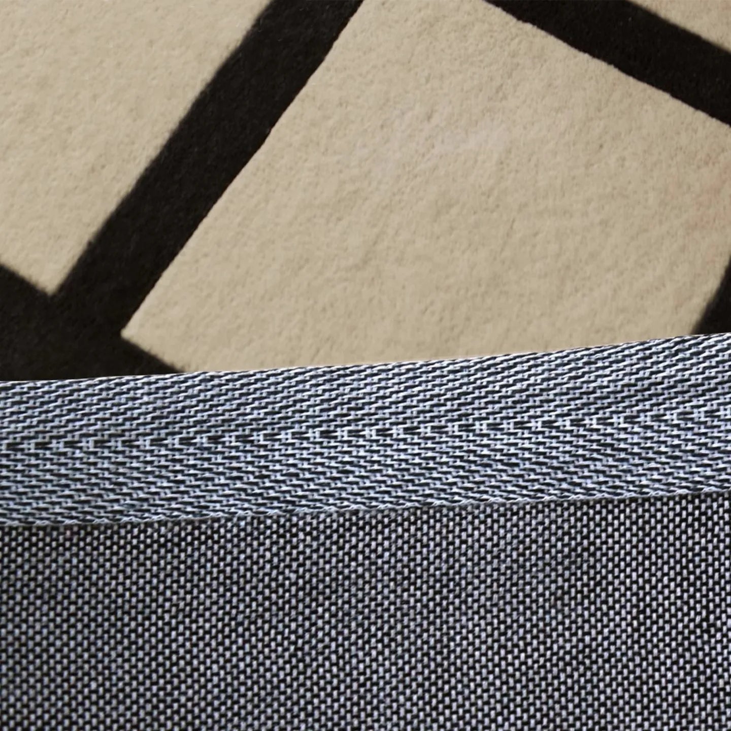 Close-up of a textured fabric backing of Studio Black and Cream Checkered Cut Pile Rug by Housenfriends