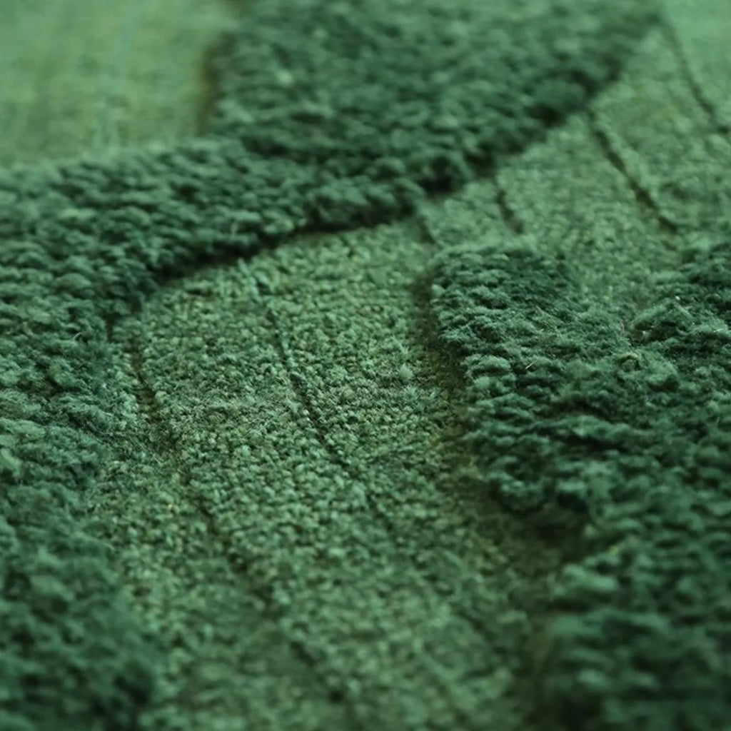 Close-up of textured high low pile fabric of Verdure Deep Green moss-inspired rug from Housenfriends
