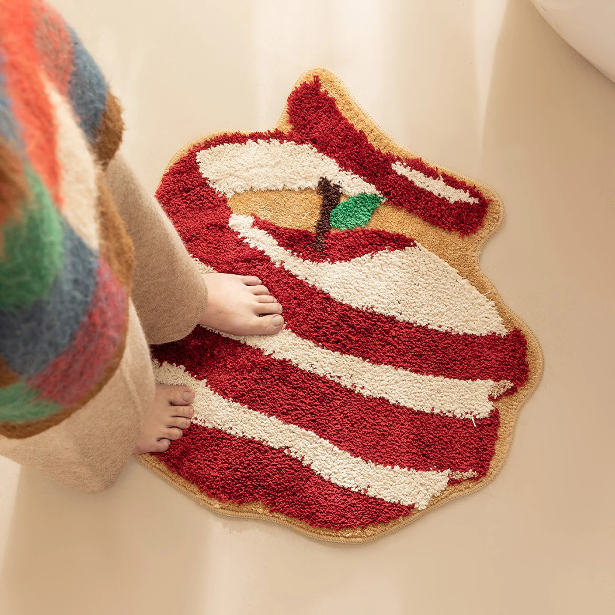 Person stepping onto Gala Peeled Red and White Apple Shaped Tufted Rug by Housenfriends