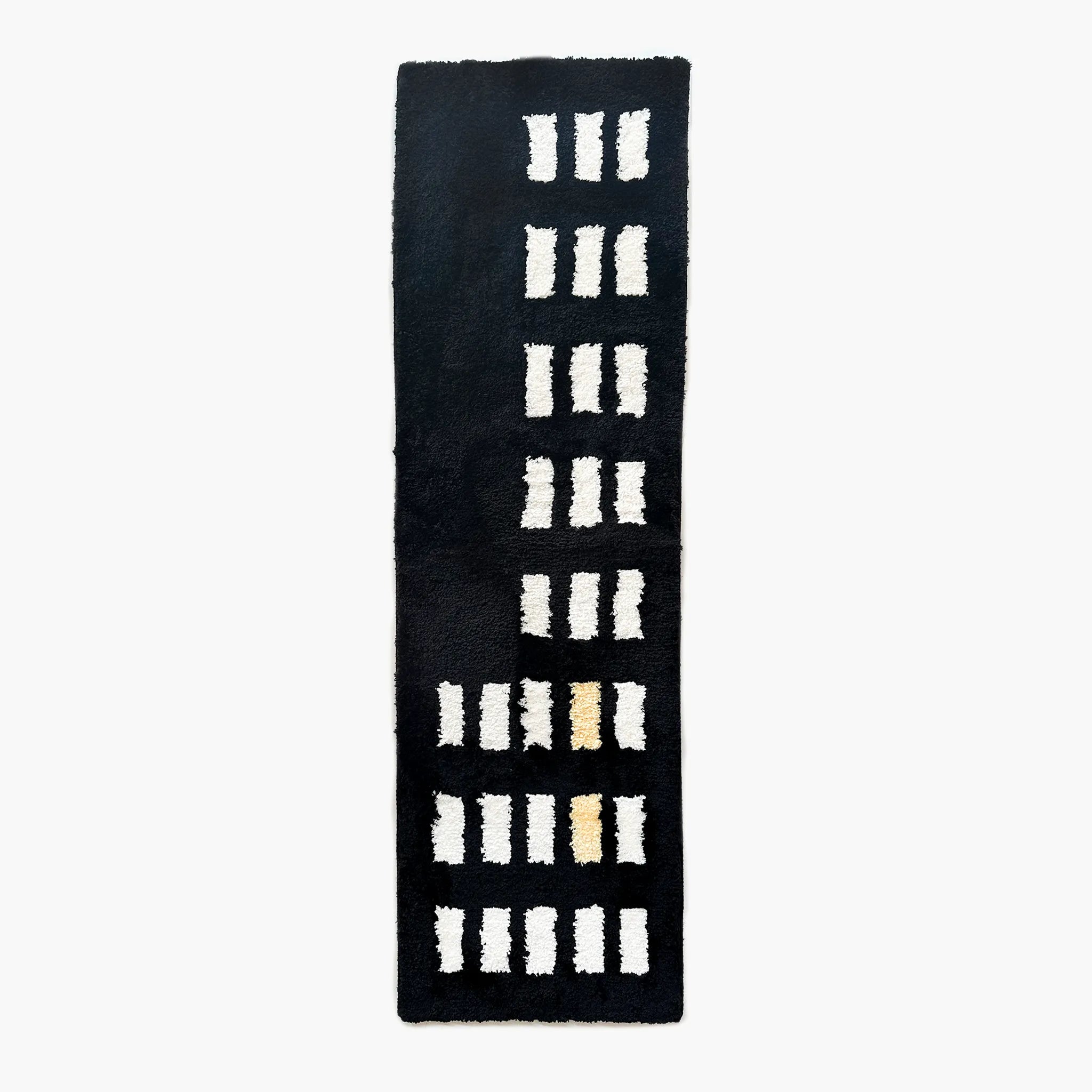 Arlo Black and White Asymmetric Checkered Tufted Runner Rug by Housenfriends on a white background