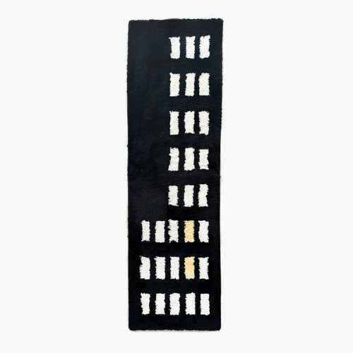 Arlo Black and White Asymmetric Checkered Tufted Runner Rug by Housenfriends on a white background