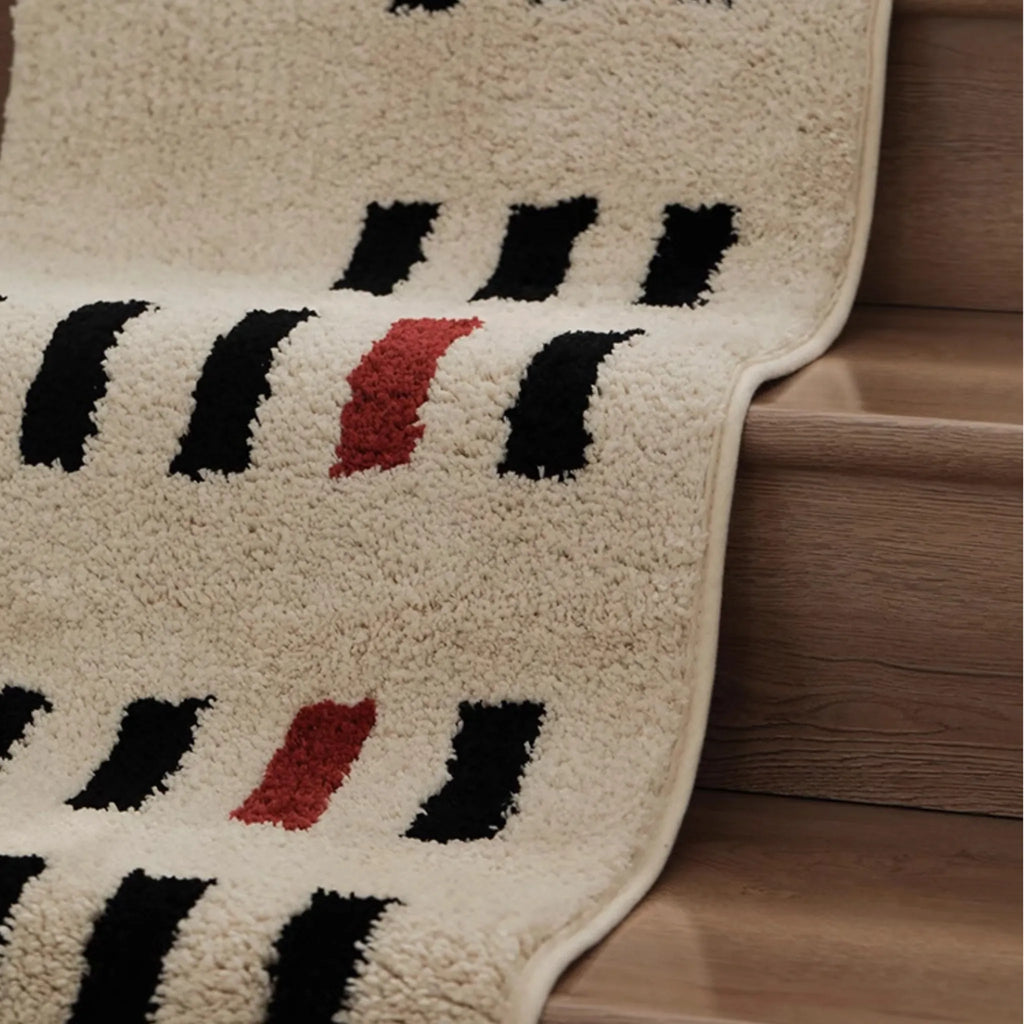 Arlo White and Black Asymmetric Checkered Tufted Runner Rug on wooden stairs