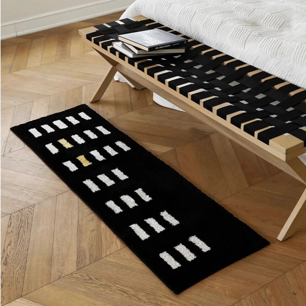 Arlo Black and White Checkered Tufted Runner by Housenfriends on a wooden floor with a wooden bench
