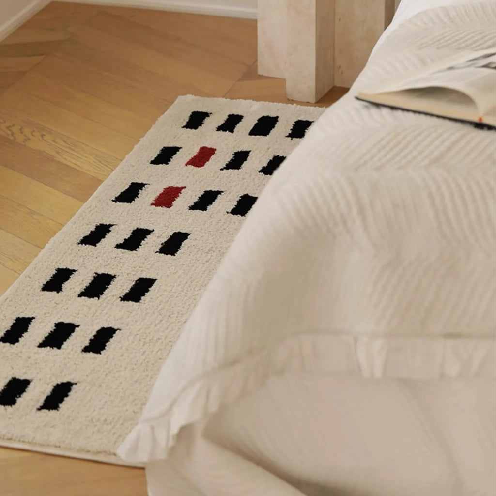 Arlo White and Black Checkered Tufted Runner by Housenfriends on wooden floor next to white bed