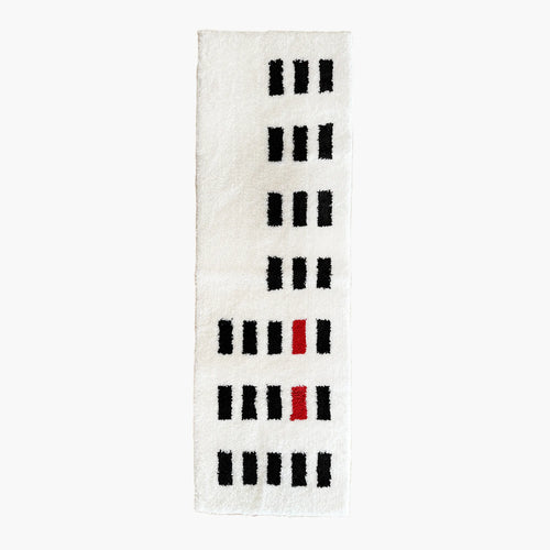 Arlo White and Black Asymmetric Checkered Tufted Runner Rug by Housenfriends on a white background