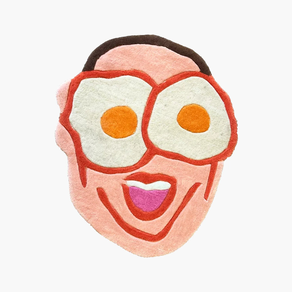 Benny Pink Goofy Fried Egg Face Shaped Tufted Rug by Housenfriends on a white background