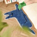Goofy Wide Eyed Blue Cat Shaped Tufted Rug on a wooden floor with a person wearing green socks.
