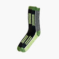 Black and green graphic striped sock shaped tufted rug by Housenfriends on a white background