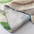 Cassia Forest Green Monstera Leaf Irregular Tufted Rug, underside backing and rug edge finish close-up