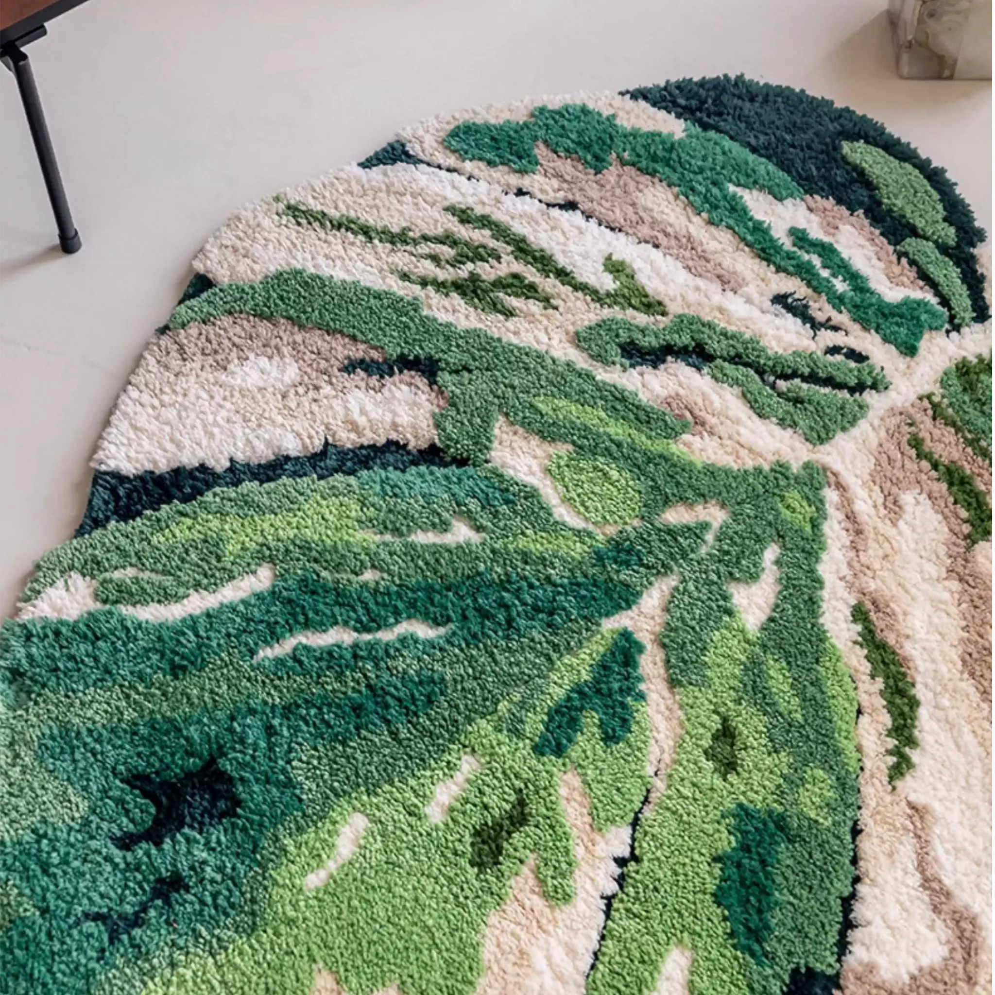 Cassia Forest Green Monstera Leaf Irregular Tufted Rug, top view showing the full leaf shape and colour blocks