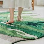 Cassia Forest Green Monstera Leaf Irregular Tufted Rug, feet on rug showing thickness and cushioned feel