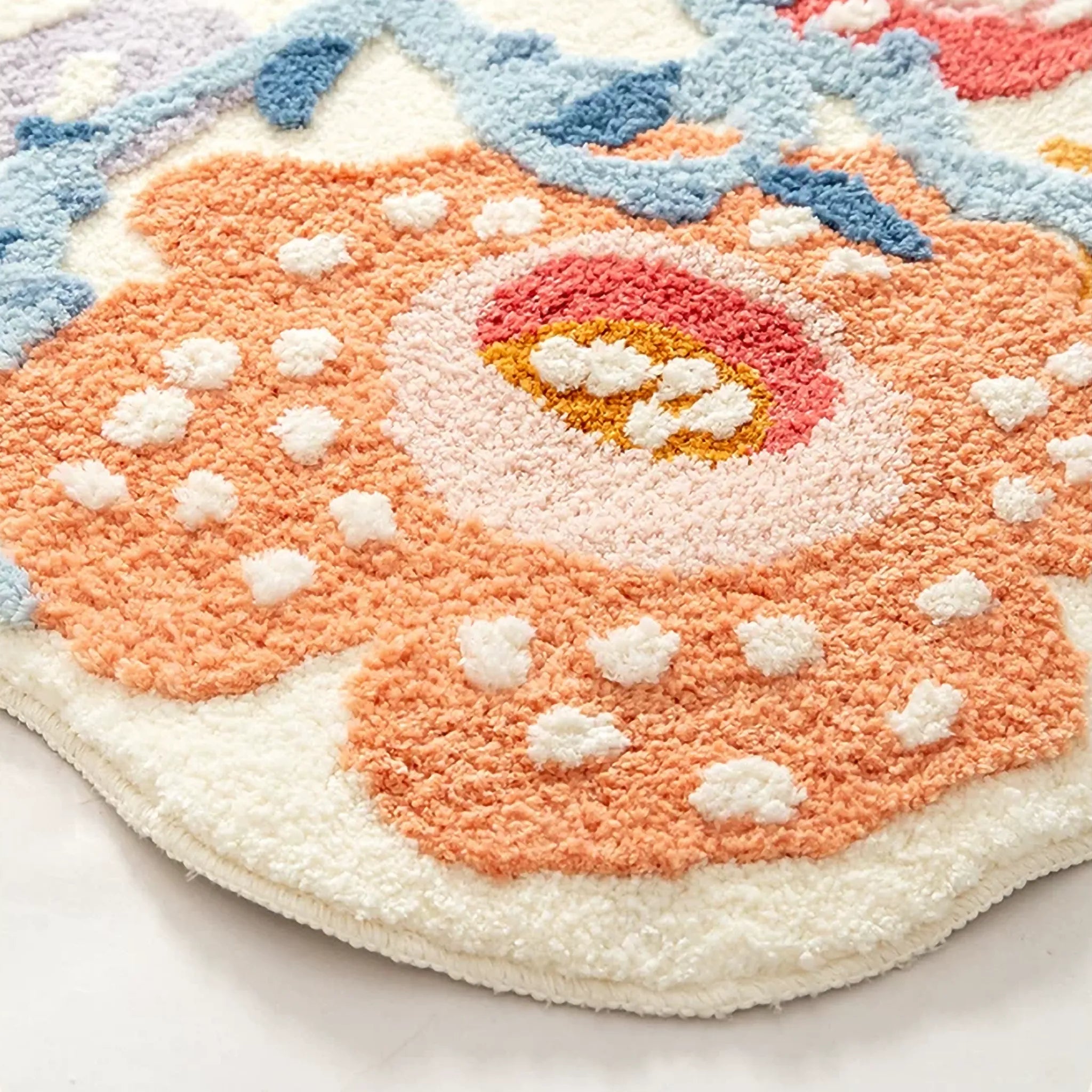 Close up of Celia orange floral runner rug with powder blue vines, raised dots and high-low tufted texture by Housenfriends
