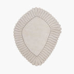 Coquille Cream Irregular Seashell Shaped Sculpted Rug with ribbed border on a white background