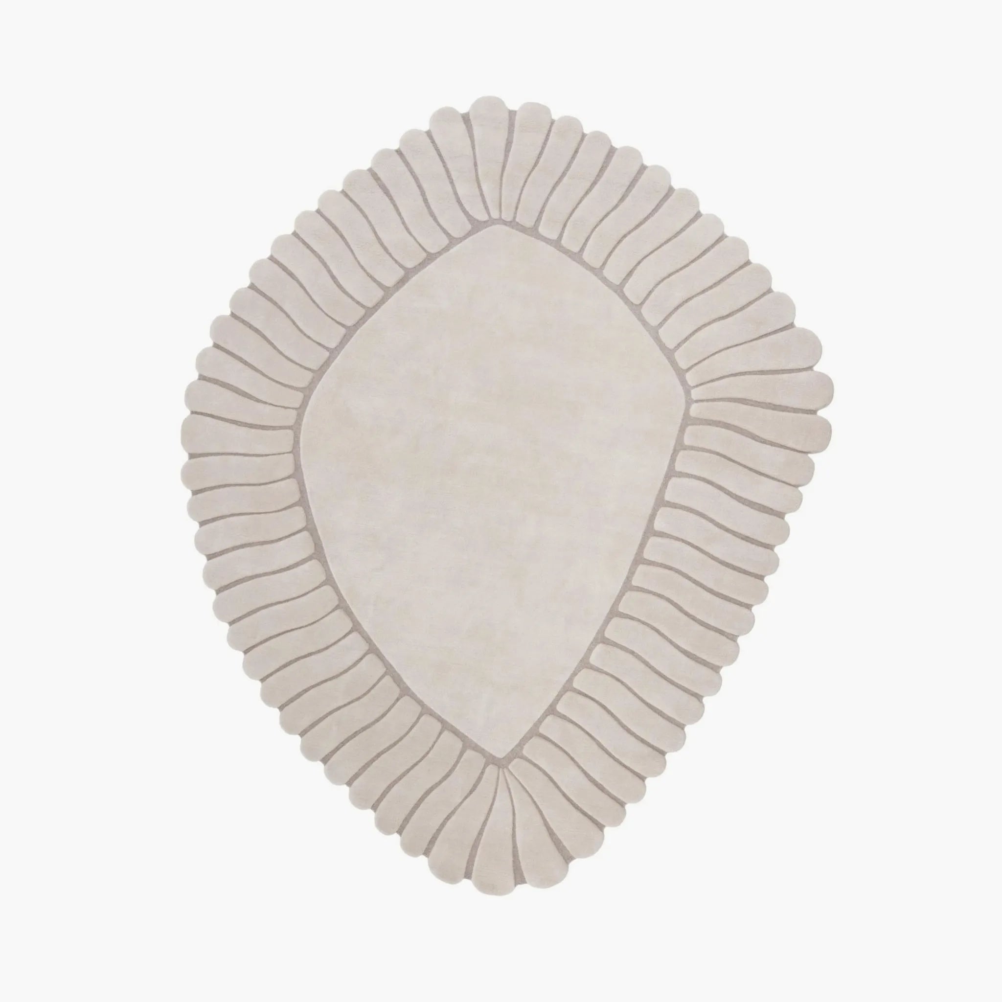 Coquille Cream Irregular Seashell Shaped Sculpted Rug with ribbed border on a white background