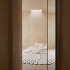 Minimalist bedroom with a bed and Coquille Cream Seashell Shaped Sculpted Rug by Housenfriends