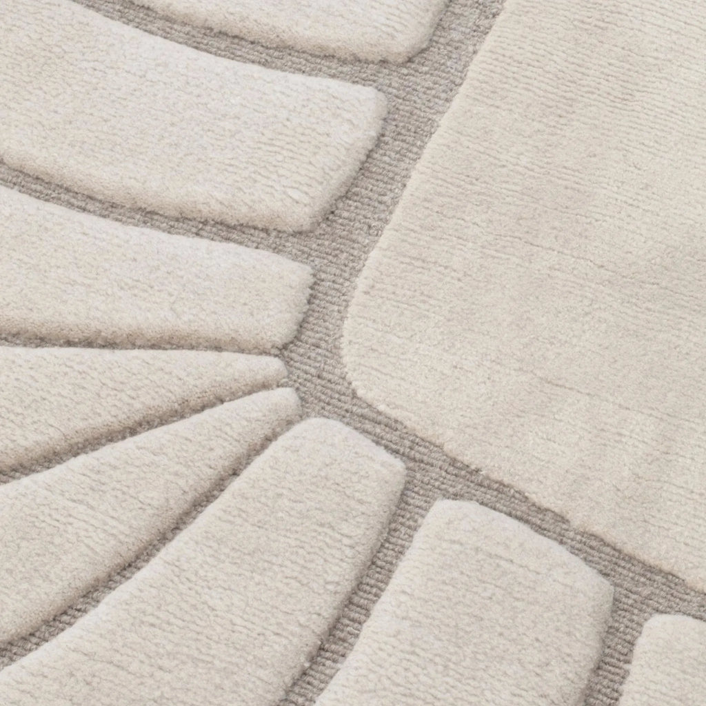 Close-up of a texture of Coquille Cream Seashell Shaped Sculpted Rug by Housenfriends
