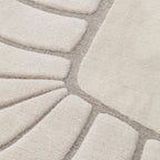Close-up of a texture of Coquille Cream Seashell Shaped Sculpted Rug by Housenfriends