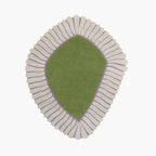 Coquille Green Seashell Shaped Sculpted Rug with cream ribbed border on a white background