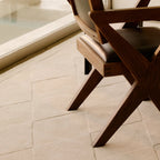 Wooden chair on the Cream Diamond Modern High Low Hand Tufted Rug by Housenfriends