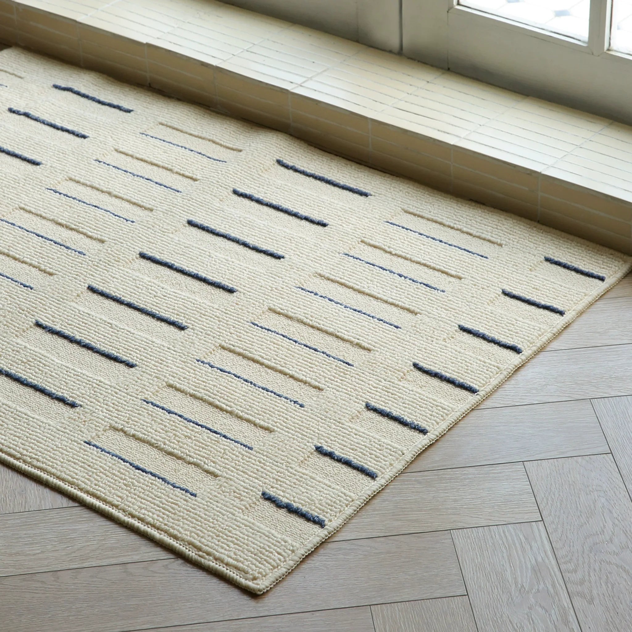 Housenfriends Elio Beige & Navy Striped High-Low Textured Rug angle view showing high-low stripe pattern